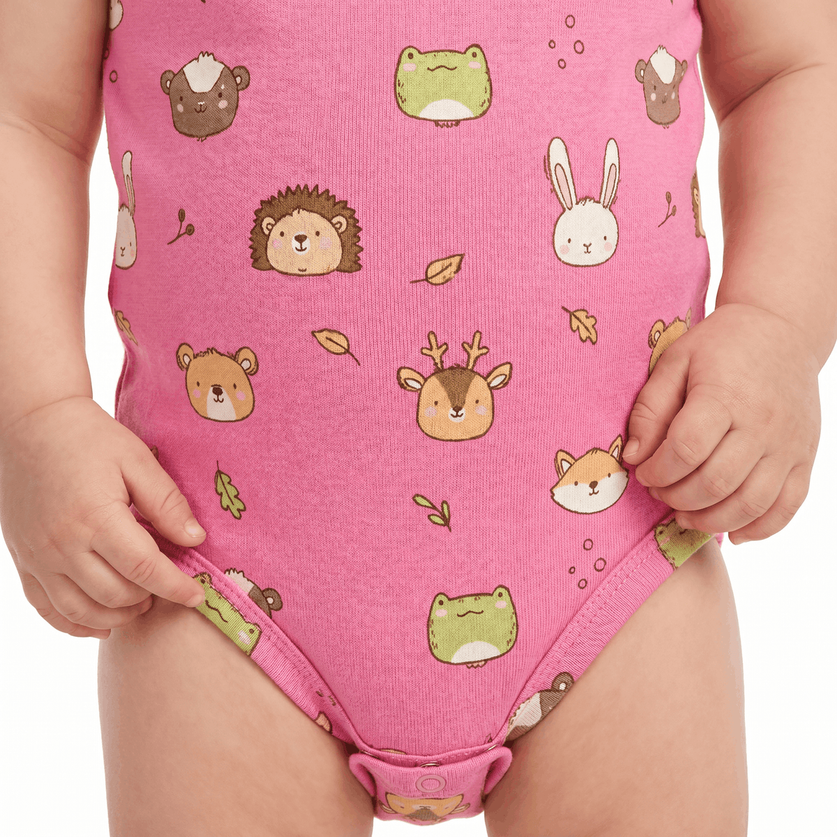A close-up of a child wearing a pink one-piece romper with a cute animal print featuring bears, foxes, rabbits, hedgehogs, and frogs.